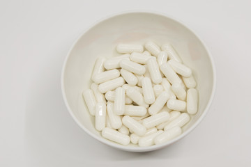 Capsule on white dish