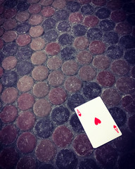 Ace of hearts card on the dirty floor