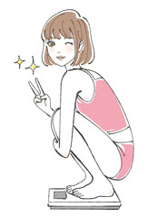 体重計に乗って喜ぶ女性