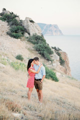 Young Stylish Couple in Love Walking in Mountains by the Sea. Vine Sunset Summer Mood