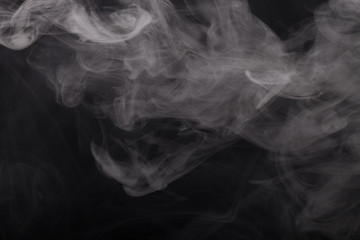 Cloud of smoke on black background. Selective focus