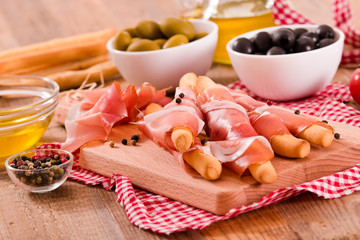 Grissini breadsticks with ham. 