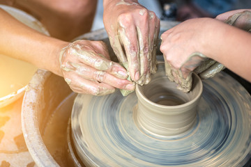 Ceramic teacher teaches students to do.