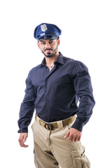 Handsome muscular male posing confidently in police cap and uniform on white background. 