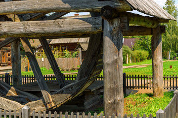 Old wooden mill wheel on a sunny summer day.