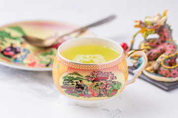A cup of green tea on a white background. Hot drink