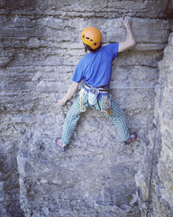 Rock climber reaching for his next hand hold, Joshua Tree National Park.