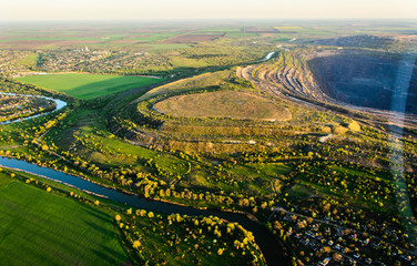 Aerial shot of huge open pit at sunset