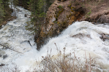 Mountain waterfall. Water flows from the rock.