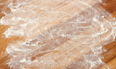 white flour on rustic wooden table, top view