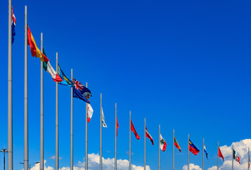 International flags against a blue sky