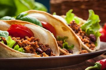 Mexican tacos with minced meat, beans and spices