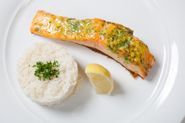 Salmon stake with boiled rise on a white background