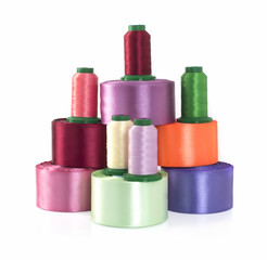Silk thread and satin ribbons for needlework on a white background