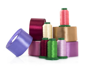 Silk thread and satin ribbons for needlework on a white background