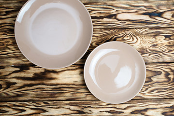 Empty brown plate on wooden table