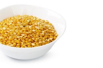 Dry yellow split peas isolated on white.