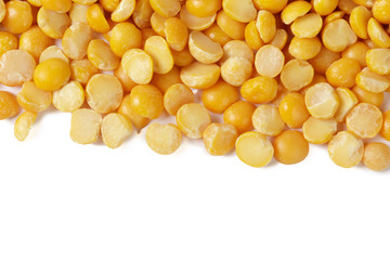 Dry yellow split peas isolated on white.
