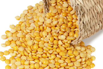 Dry yellow split peas isolated on white.
