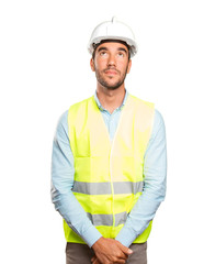 Confident engineer looking up against white background