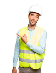 Surprised engineer pointing against white background