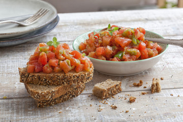 Italian bruschetta with tomato, bell pepper, garlic, olive oil and basil.