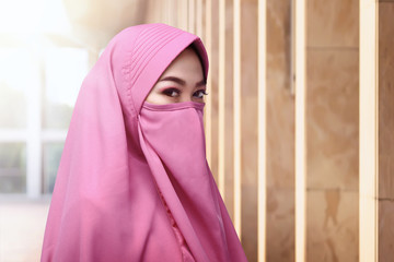 Stare of asian muslim woman wearing face covering