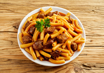 Plate of Italian rigatoni pasta with sauce