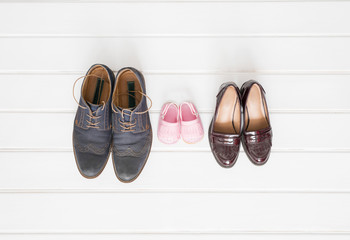 Woman's, man's, and children shoes on white background