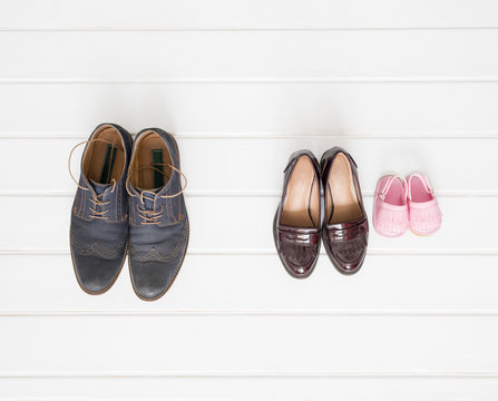 Males, females and children shoes setup on white background