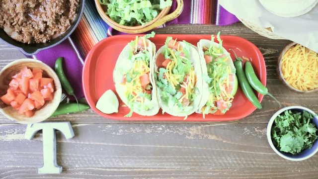 Ground Beef Tacos With Romaine Lettuce, Diced Tomatoes, And Shredded Cheddar Cheese