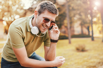 Young man talking on a mobile phone outdoors