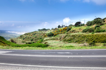 Asphalt road . Clouds on blue sky in summer day