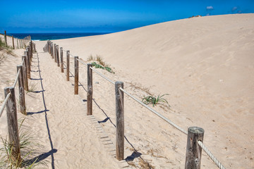 Wooden board path way to the sandy beach