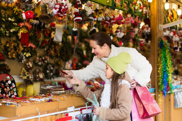 Mother with daughter in Christmas market