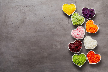 Vertical row of heart-shaped bowls of vegetables