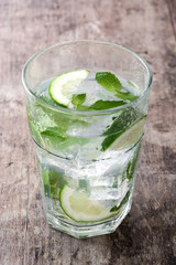 Mojito cocktail in glass on wooden background


