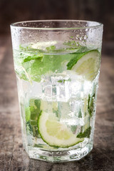 Mojito cocktail in glass on wooden background

