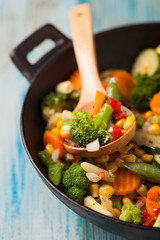 Mix of vegetables fried in a wok.