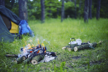 Cooking breakfast on a campfire at a summer camp.
