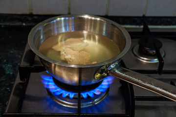 Cooking chicken broth on gas stove