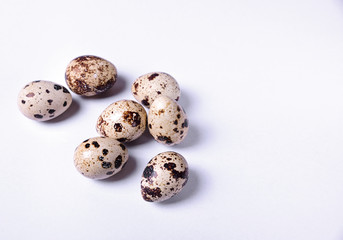 Fototapeta premium Group of quail eggs on a white surface