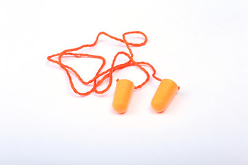 Orange earplug for work. Earplug to reduce noise on a white background .