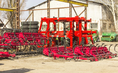 Fototapeta na wymiar Harvesters and harvester parts at the plant are waiting for assembly, tractors and agricultural machinery