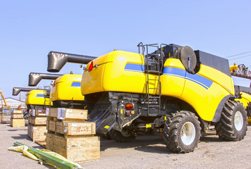 Harvesters and harvester parts at the plant are waiting for assembly, tractors and agricultural machinery