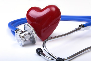 Medical stethoscope and red heart isolated on white