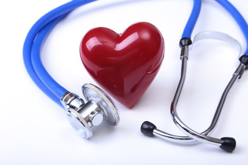 Medical stethoscope and red heart isolated on white