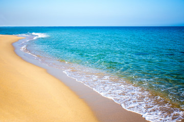 Fototapeta na wymiar beach background with sand, sea and clear sky