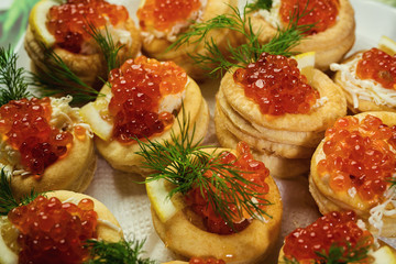 Tartlet with red caviar,Tartlet with red caviar close up. Snacks with red caviar, gourmet food, appetizer,The tartlets filling of mascarpone