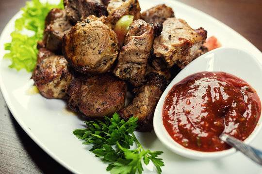 Delicious grilled pork meat and kebabs,Grilled meat,Shashlik. pieces of grilled meat,Grilled meat with souce,tasty grilled meat